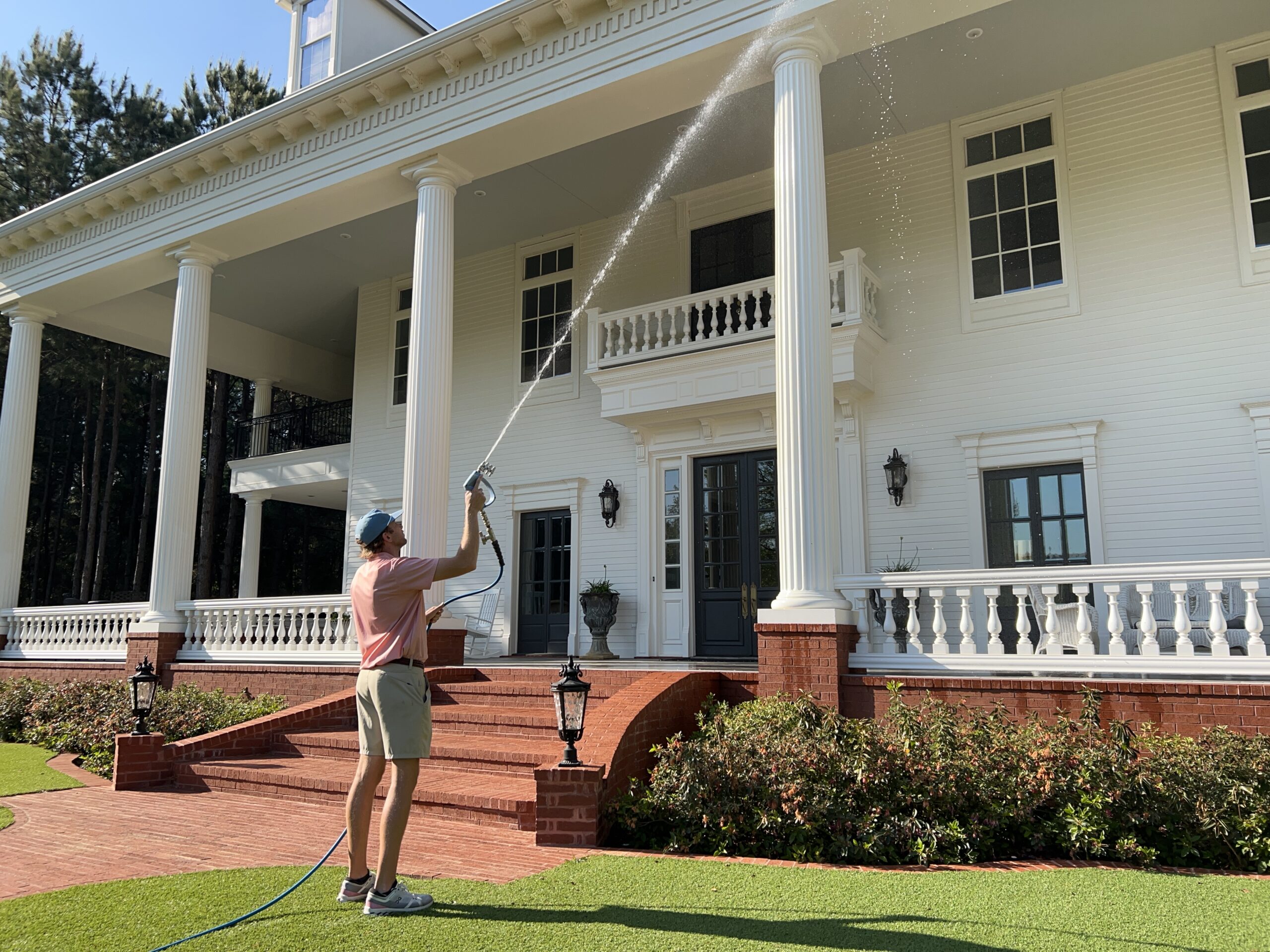 Harrison Price power washing a residential home exterior